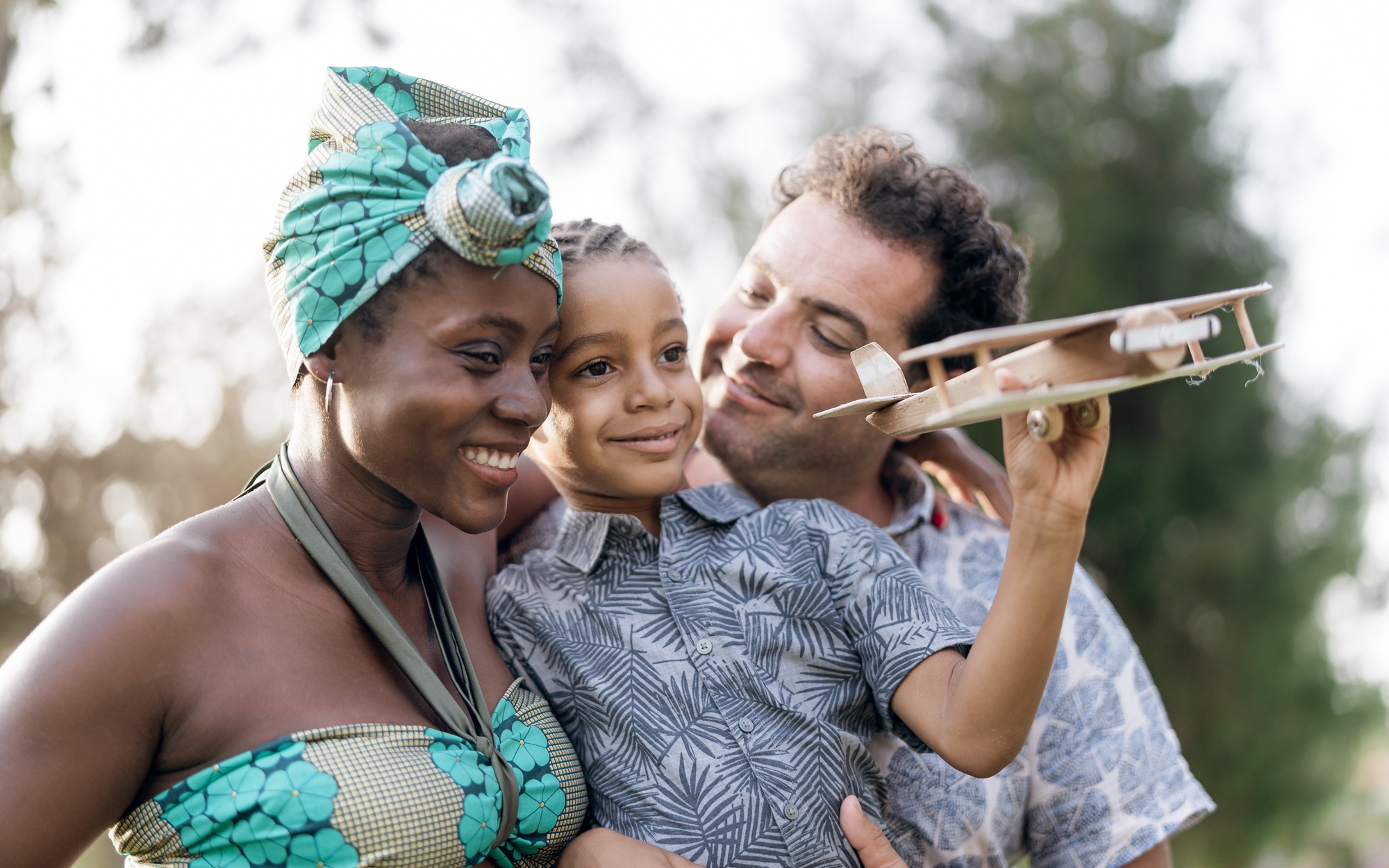 Happy multiracial family having fun together in park