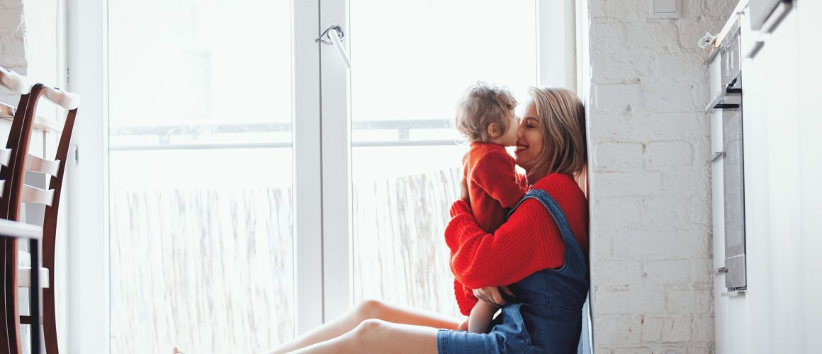 girl with a toddler boy is sitting at the threshold