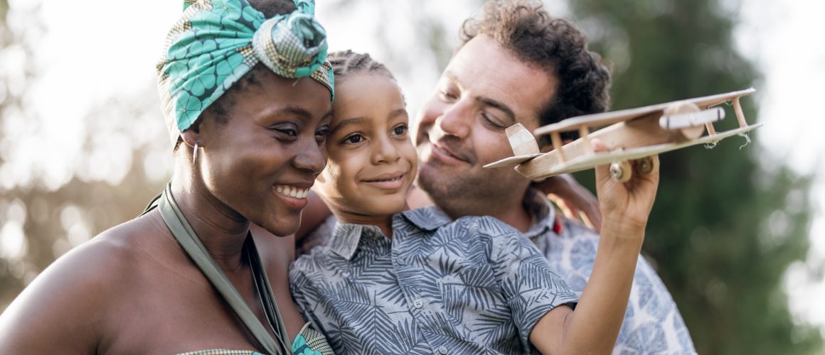 Happy multiracial family having fun together in park